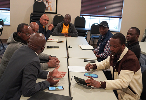 Photo of several men at a meeting of African Economic Development Solutions