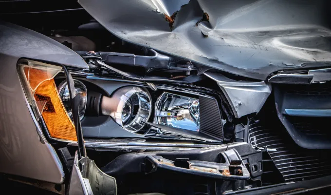 Photo of a crumpled fender of a car due to a traffic accident