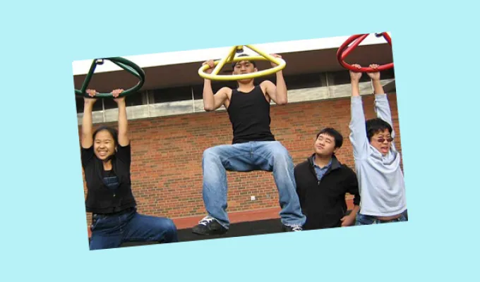 Youth hanging on playground equipment