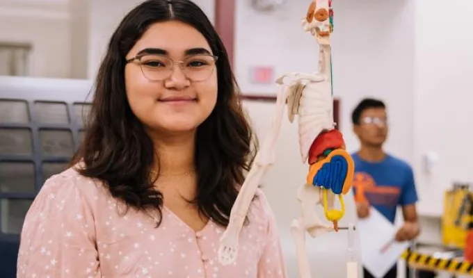 Photo of young female biology student. Photo by Jeswin Thomas on Unsplash