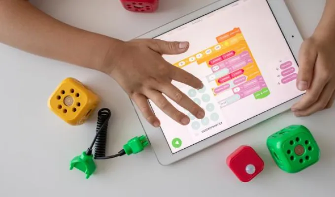 Close-up of young hands using a laptop. Photo by Robo Wunderkind on Upsplash.