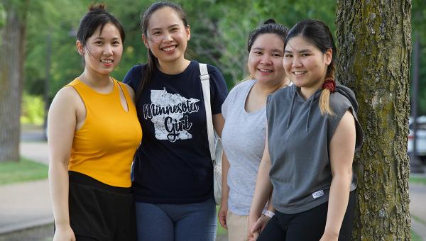 Four young Asian Minnesotan women smiling at the camera.