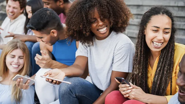 Photo of several young people sitting on steps, enjoying each other's company